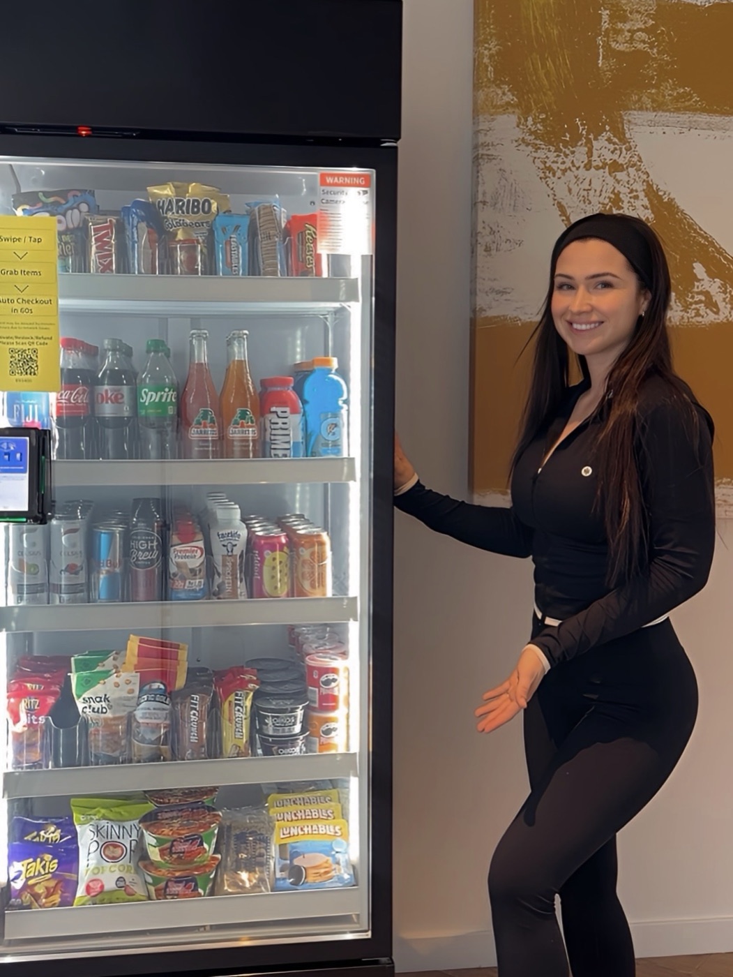 Madison next to one of her vending machines